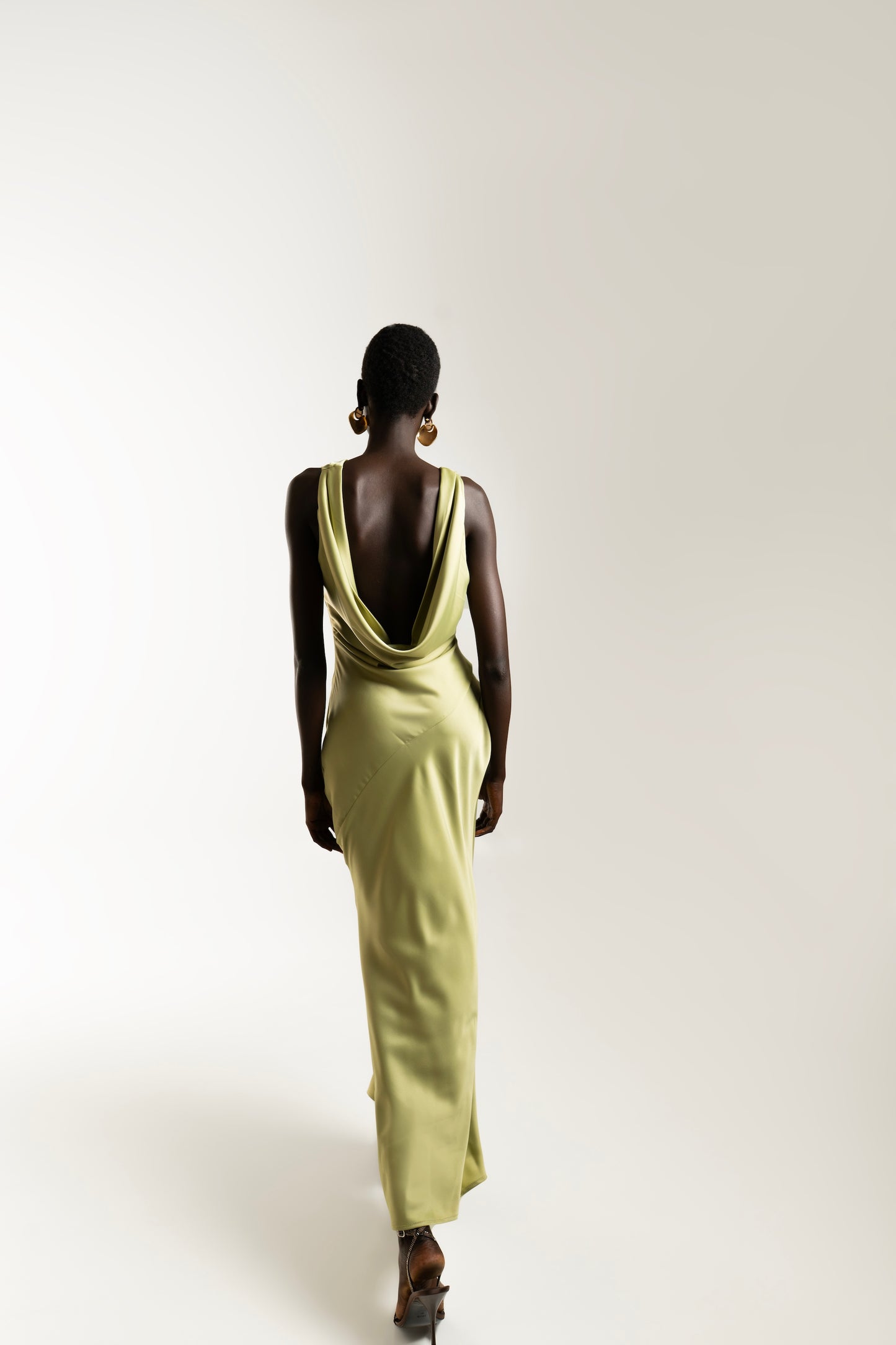 IRA by Irini Charalampous, @irathebrand online shop fashionable ready-to-wear womenswear brand KAIA satin basic maxi dress with open back and tie detail in olive green color. Shop online from Cyprus and Greece.