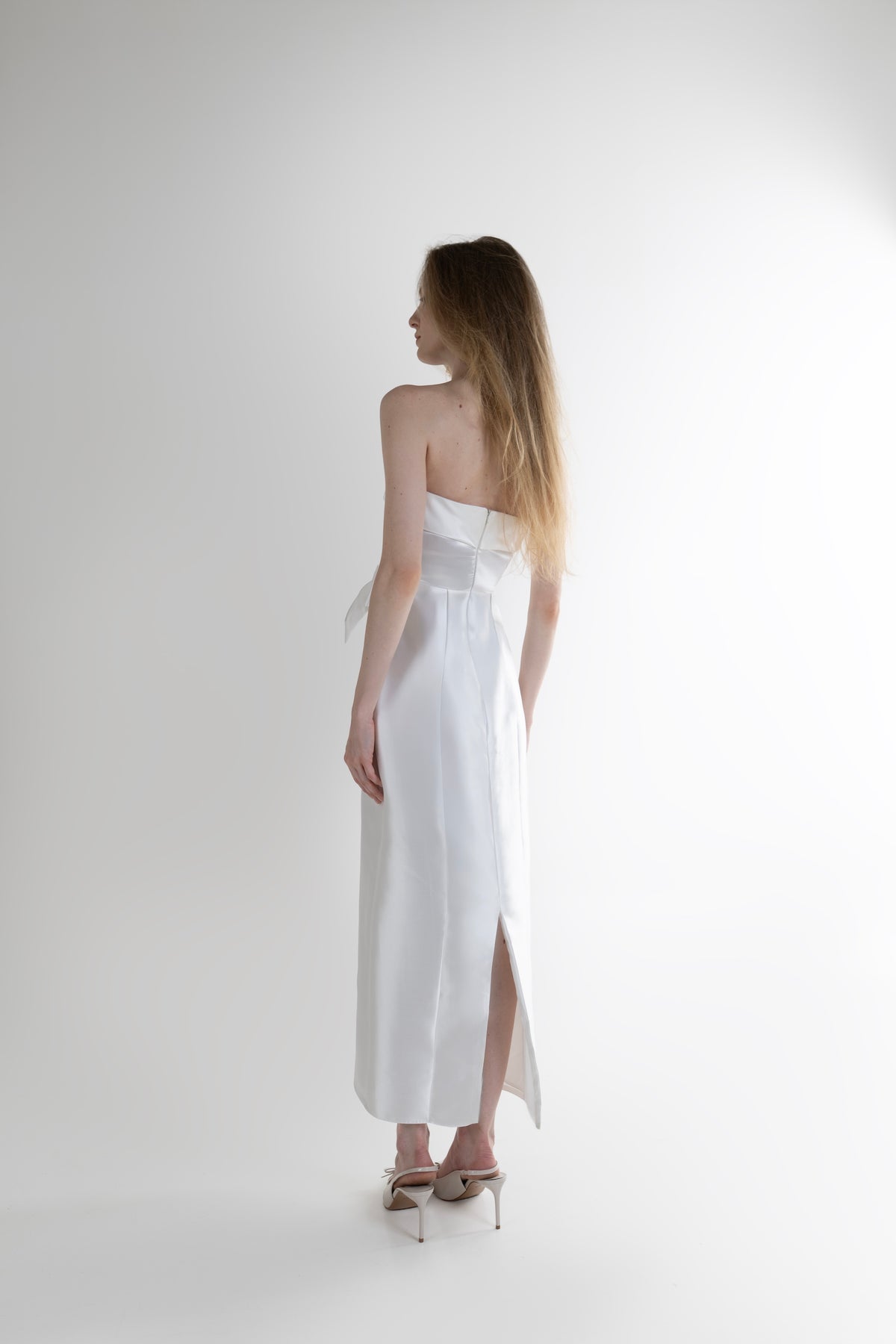 IRA by Irini Charalampous, @irathebrand online shop fashionable ready-to-wear womenswear brand CELIA strapless midi dress featuring bow appliqué detailing and tailored silhouette in white color. Shop online from Cyprus and Greece.