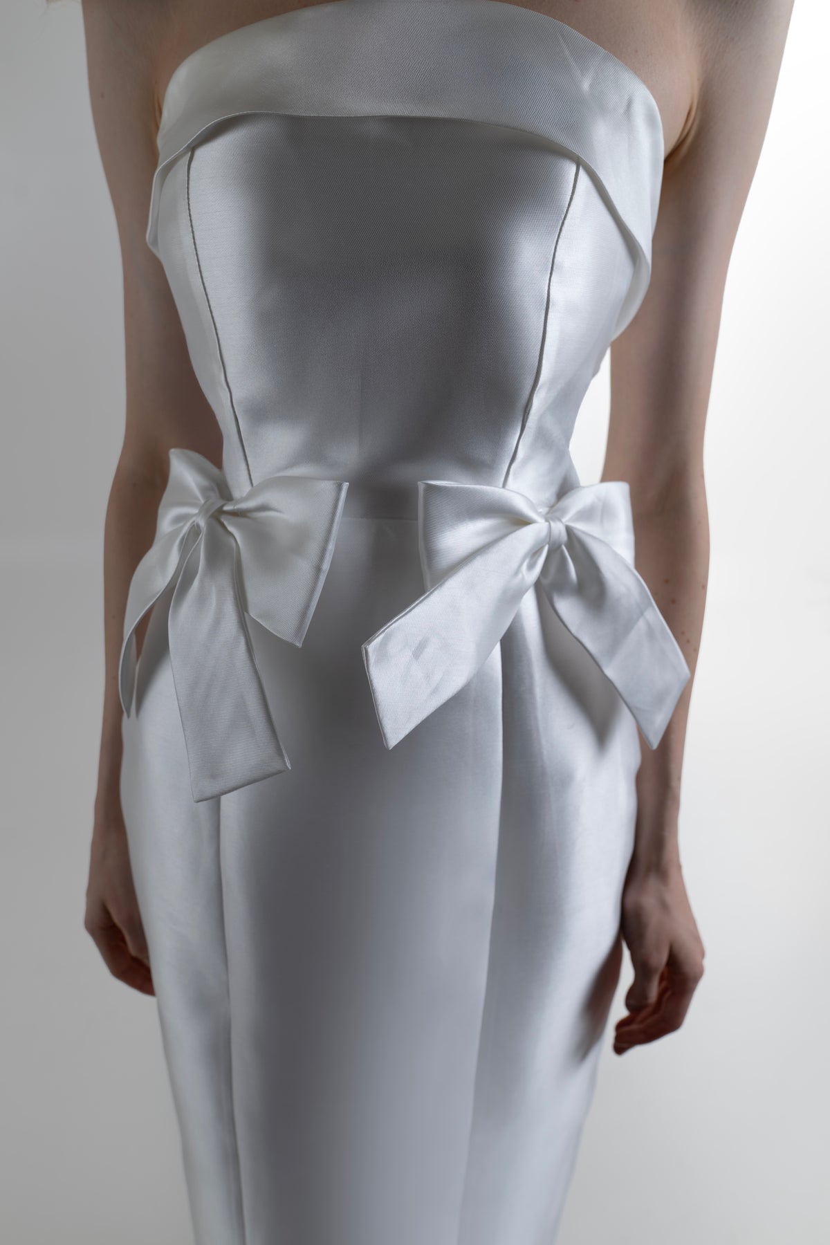 IRA by Irini Charalampous, @irathebrand online shop fashionable ready-to-wear womenswear brand CELIA strapless midi dress featuring bow appliqué detailing and tailored silhouette in white color. Shop online from Cyprus and Greece.