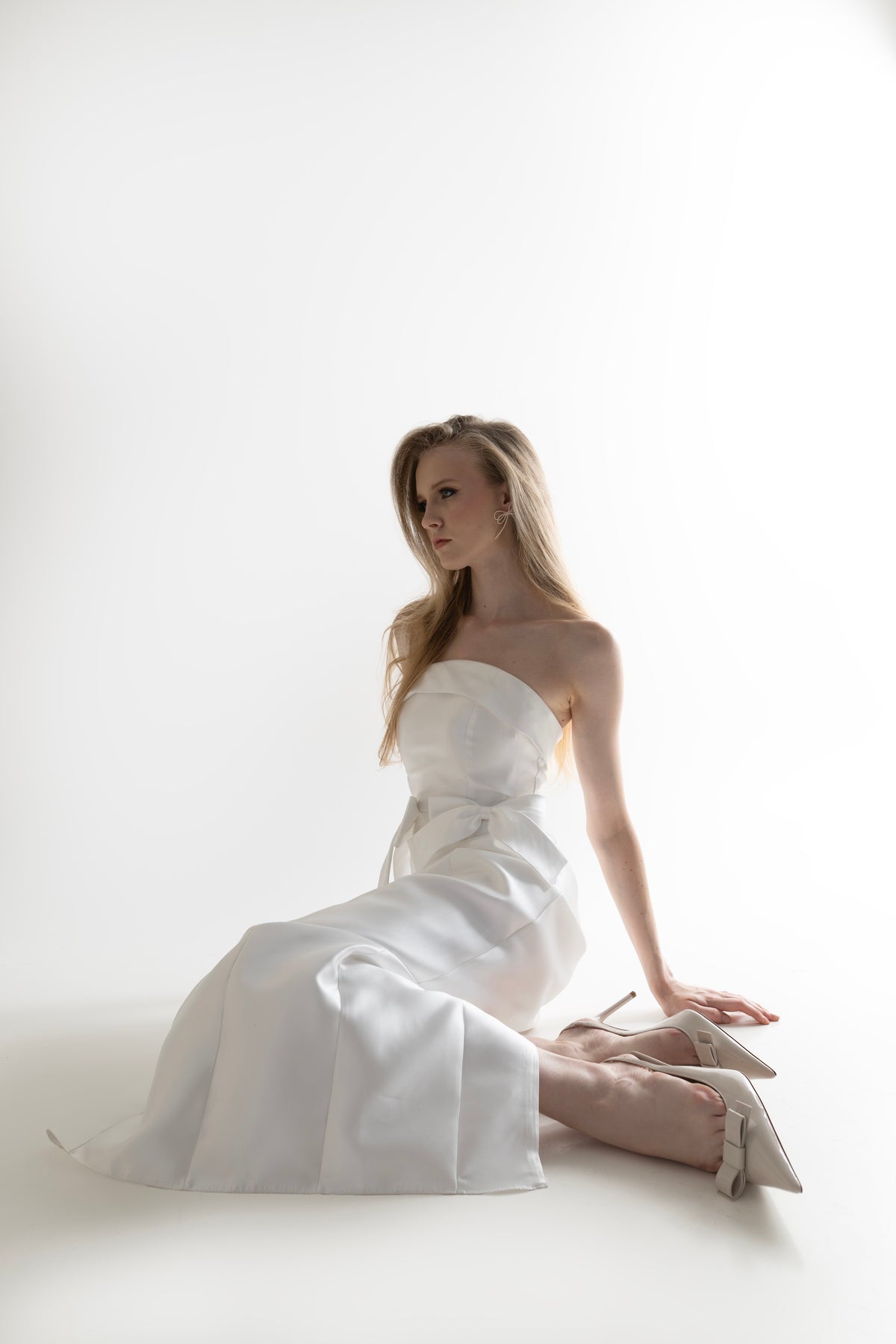 IRA by Irini Charalampous, @irathebrand online shop fashionable ready-to-wear womenswear brand CELIA strapless midi dress featuring bow appliqué detailing and tailored silhouette in white color. Shop online from Cyprus and Greece.