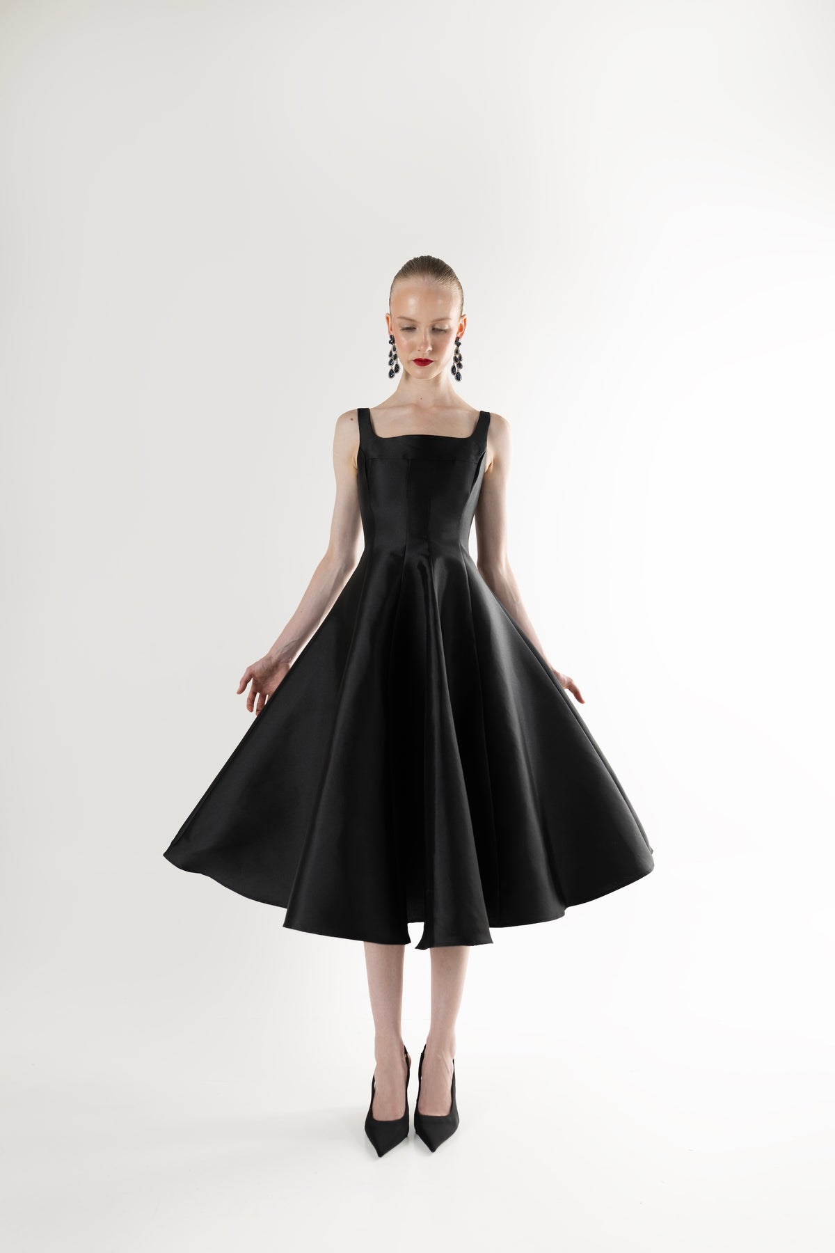 IRA by Irini Charalampous, @irathebrand online shop fashionable ready-to-wear womenswear brand NINA sleeveless midi dress with square neckline featuring a sculpted bodice and circle full skirt in black color. Shop online from Cyprus and Greece.