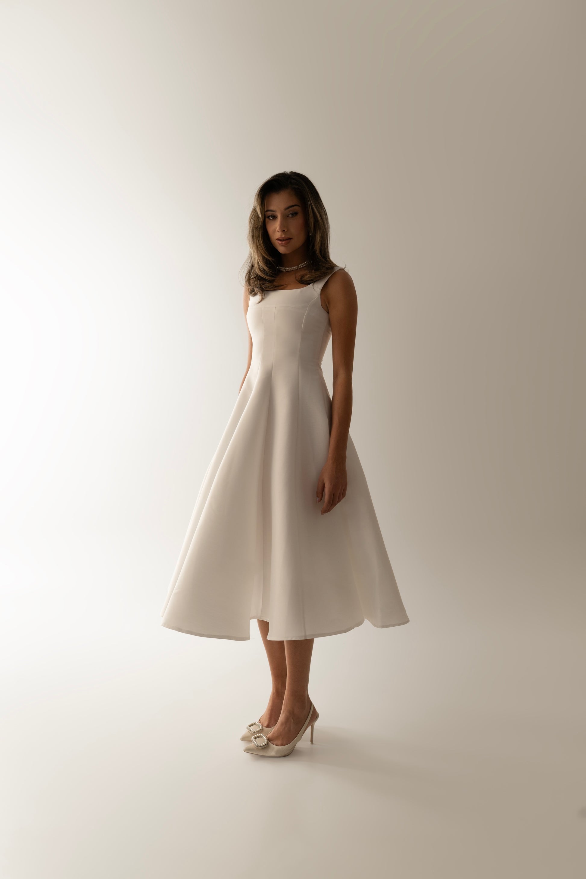 IRA by Irini Charalampous, @irathebrand online shop fashionable ready-to-wear womenswear brand sculpted bust scuba fabric NINA bridal midi dress with circle skirt in white color. Shop online from Cyprus and Greece.