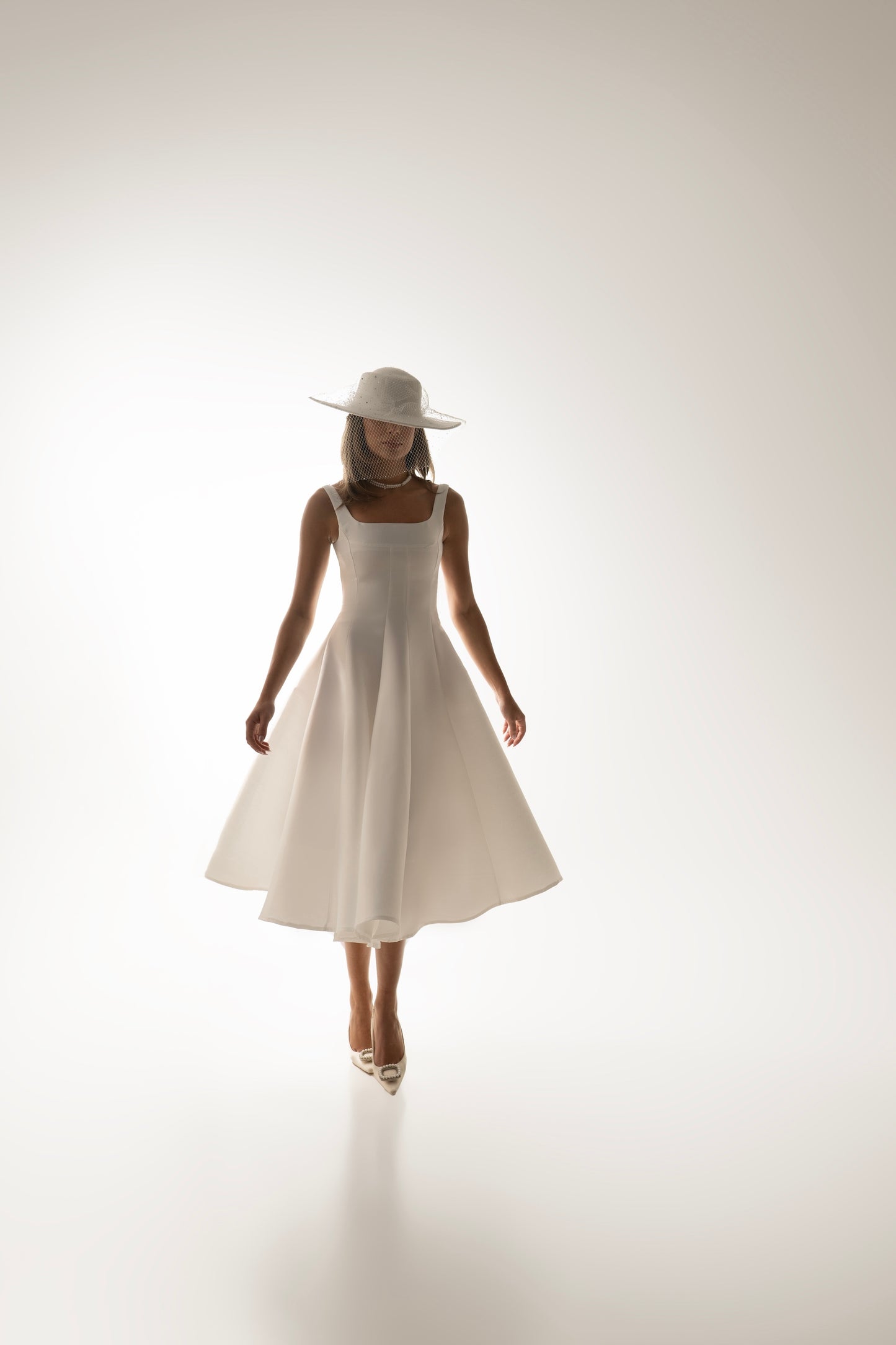 IRA by Irini Charalampous, @irathebrand online shop fashionable ready-to-wear womenswear brand sculpted bust scuba fabric NINA bridal midi dress with circle skirt in white color. Shop online from Cyprus and Greece.