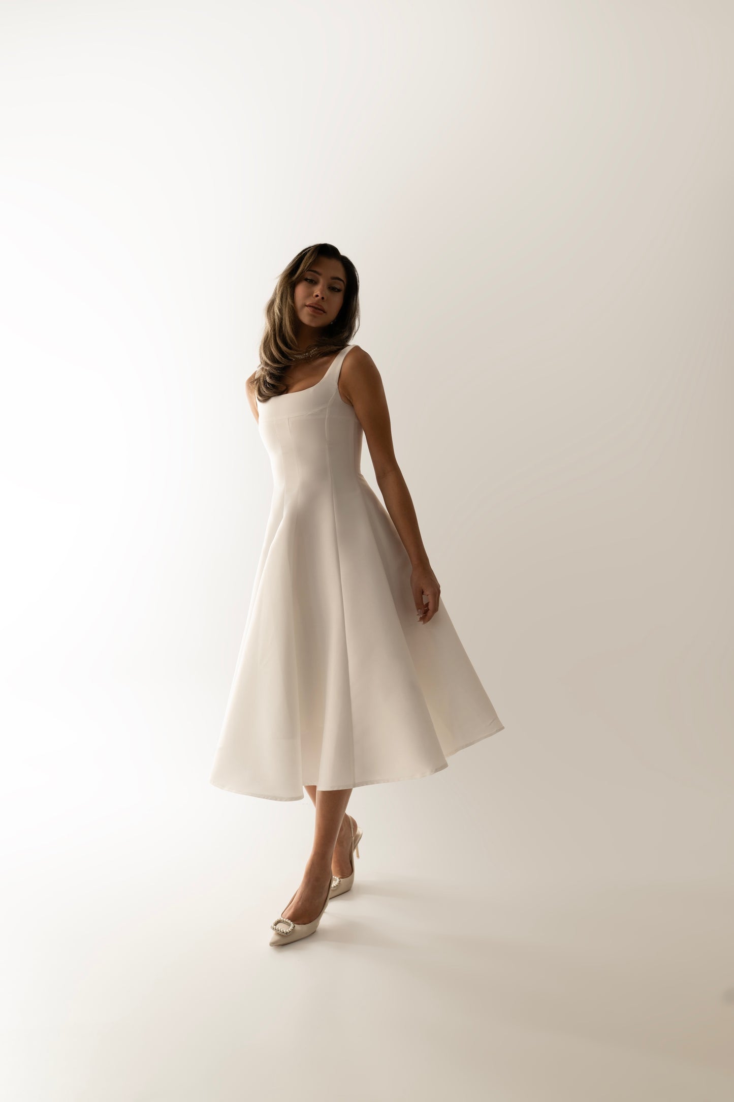 IRA by Irini Charalampous, @irathebrand online shop fashionable ready-to-wear womenswear brand sculpted bust scuba fabric NINA bridal midi dress with circle skirt in white color. Shop online from Cyprus and Greece.