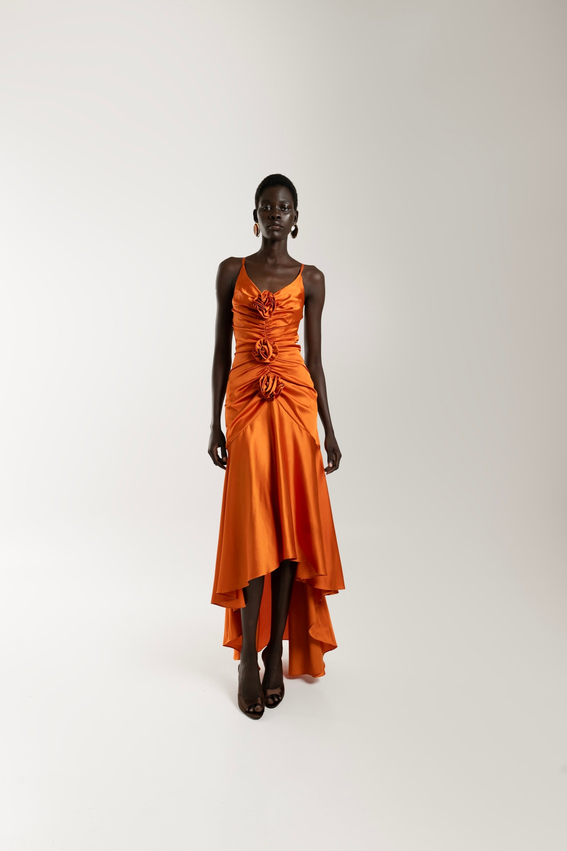 IRA by Irini Charalampous, @irathebrand online shop fashionable ready-to-wear womenswear brand CORA satin plunging neckline with ruching at the waist and roses maxi dress in orange color. Shop online from Cyprus and Greece.