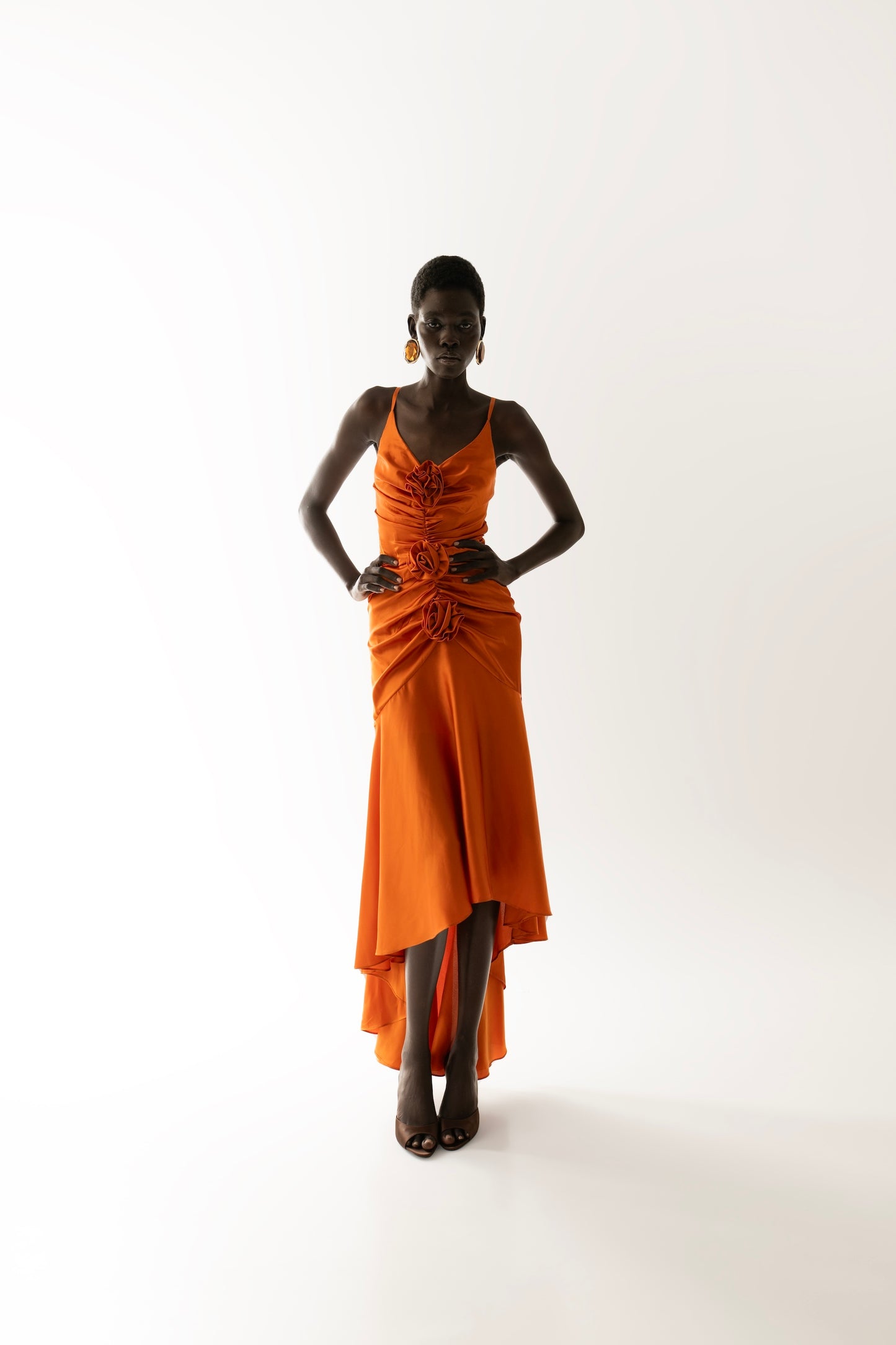 IRA by Irini Charalampous, @irathebrand online shop fashionable ready-to-wear womenswear brand CORA satin plunging neckline with ruching at the waist and roses maxi dress in orange color. Shop online from Cyprus and Greece.