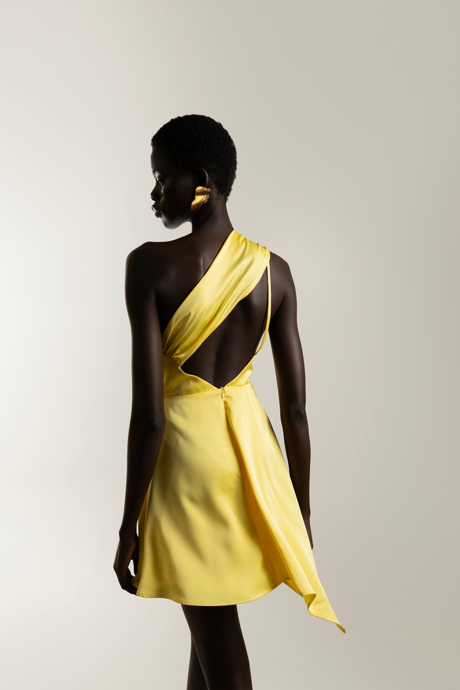 IRA by Irini Charalampous, @irathebrand online shop fashionable ready-to-wear womenswear brand LINA satin asymmetric one shoulder mini dress in yellow color. Shop online from Cyprus and Greece.