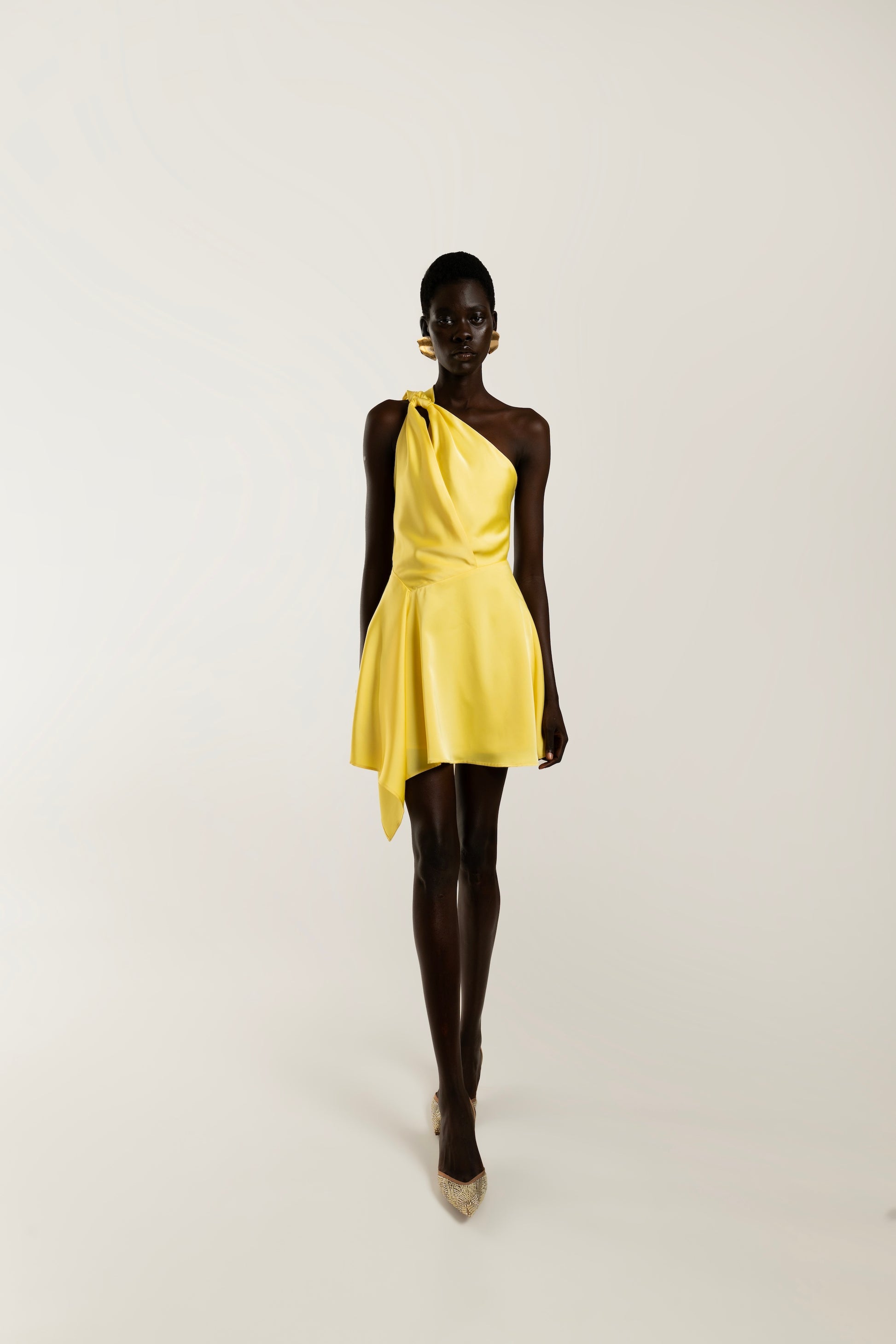 IRA by Irini Charalampous, @irathebrand online shop fashionable ready-to-wear womenswear brand LINA satin asymmetric one shoulder mini dress in yellow color. Shop online from Cyprus and Greece.
