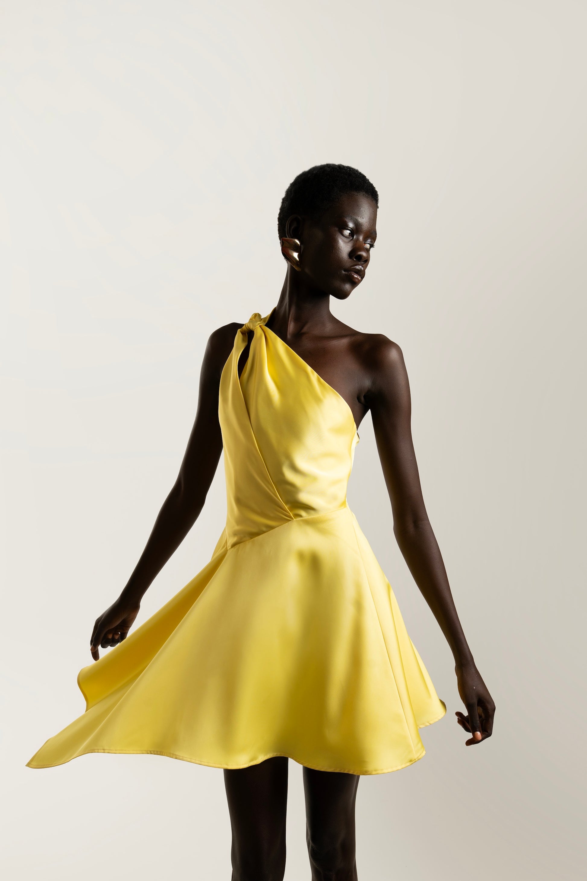 IRA by Irini Charalampous, @irathebrand online shop fashionable ready-to-wear womenswear brand LINA satin asymmetric one shoulder mini dress in yellow color. Shop online from Cyprus and Greece.