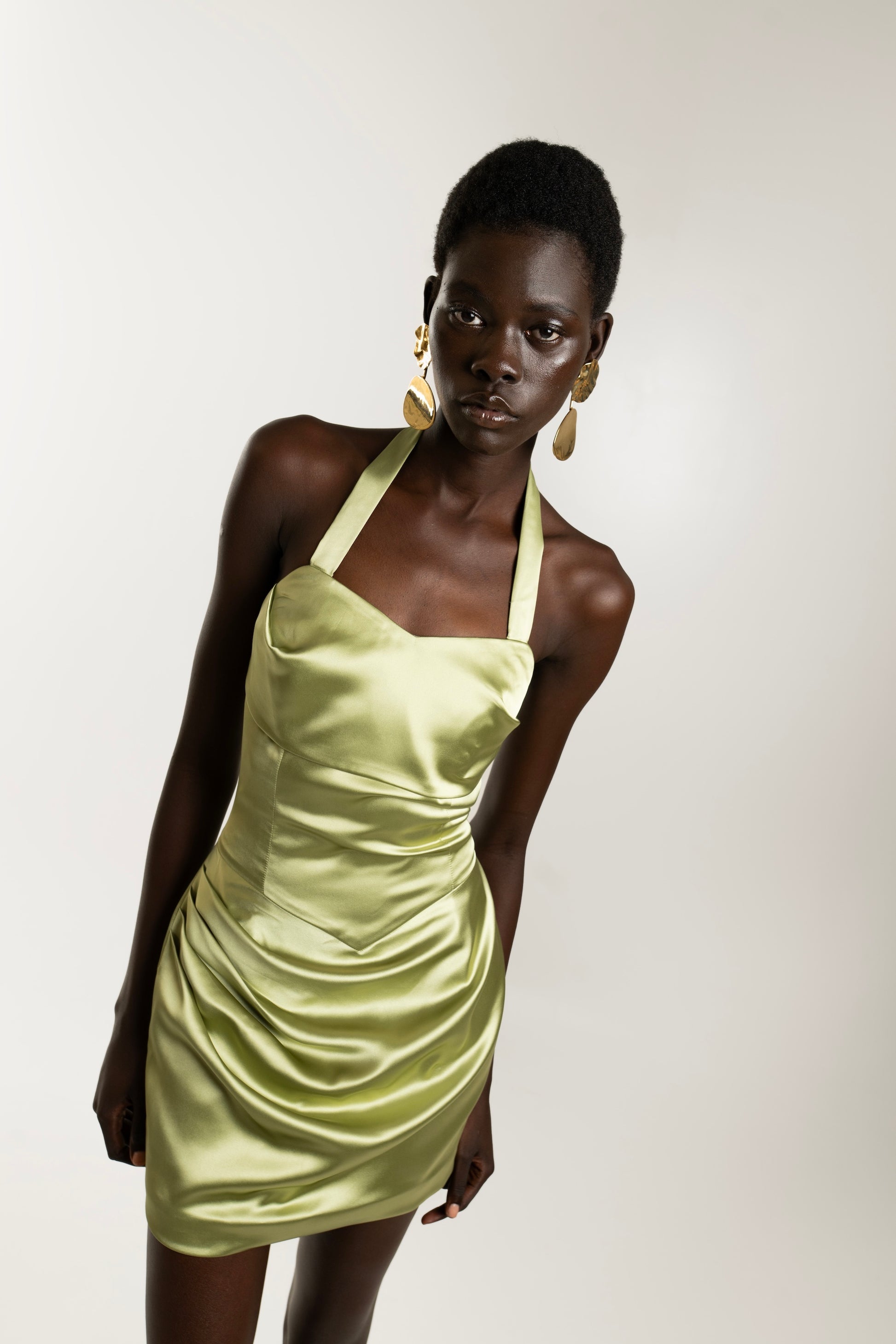 IRA by Irini Charalampous, @irathebrand online shop fashionable ready-to-wear womenswear brand AIME satin elegant
neckline and draped waist mini dress in olive color. Shop online from Cyprus and Greece.