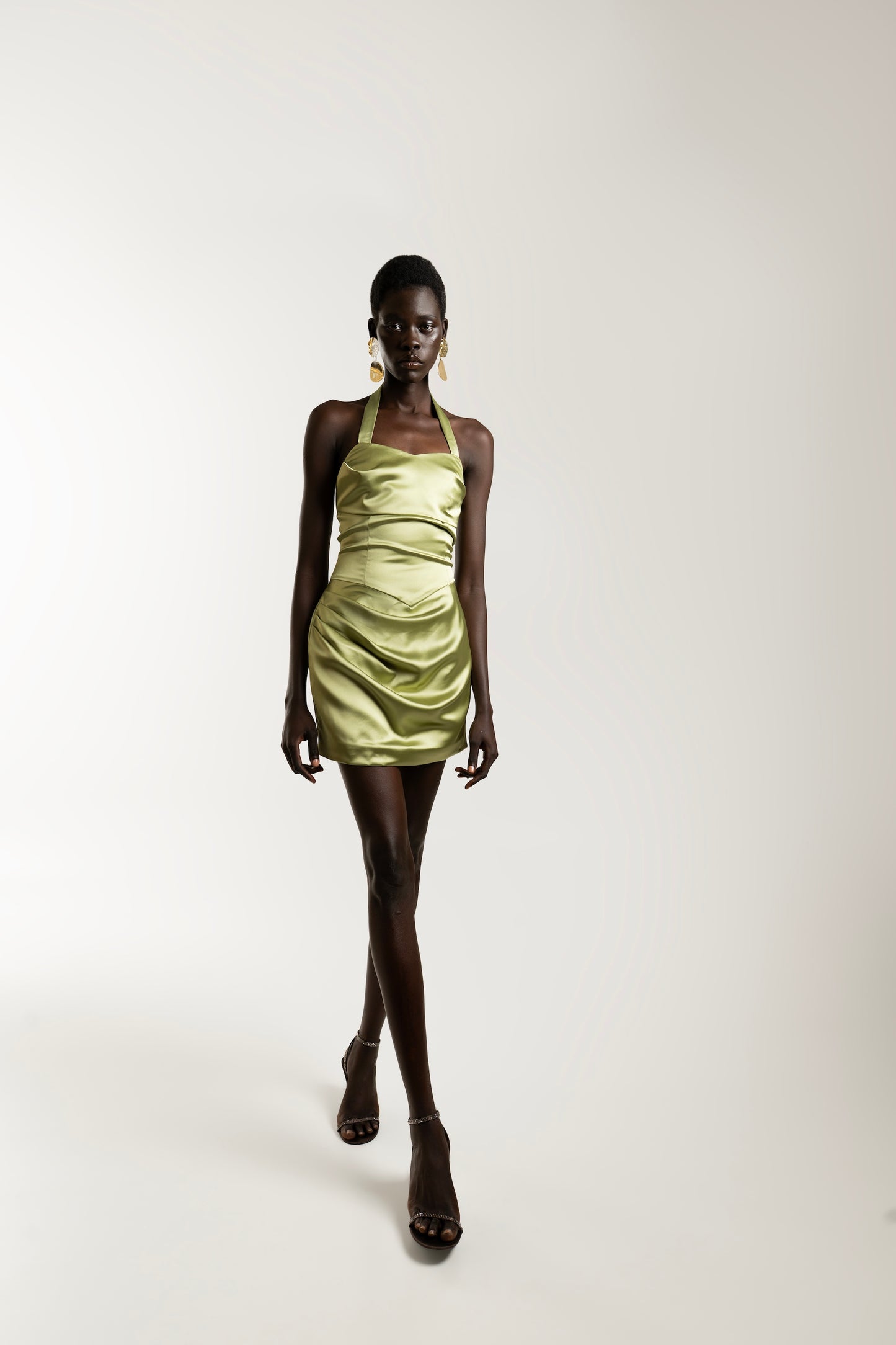 IRA by Irini Charalampous, @irathebrand online shop fashionable ready-to-wear womenswear brand AIME satin elegant
neckline and draped waist mini dress in olive color. Shop online from Cyprus and Greece.