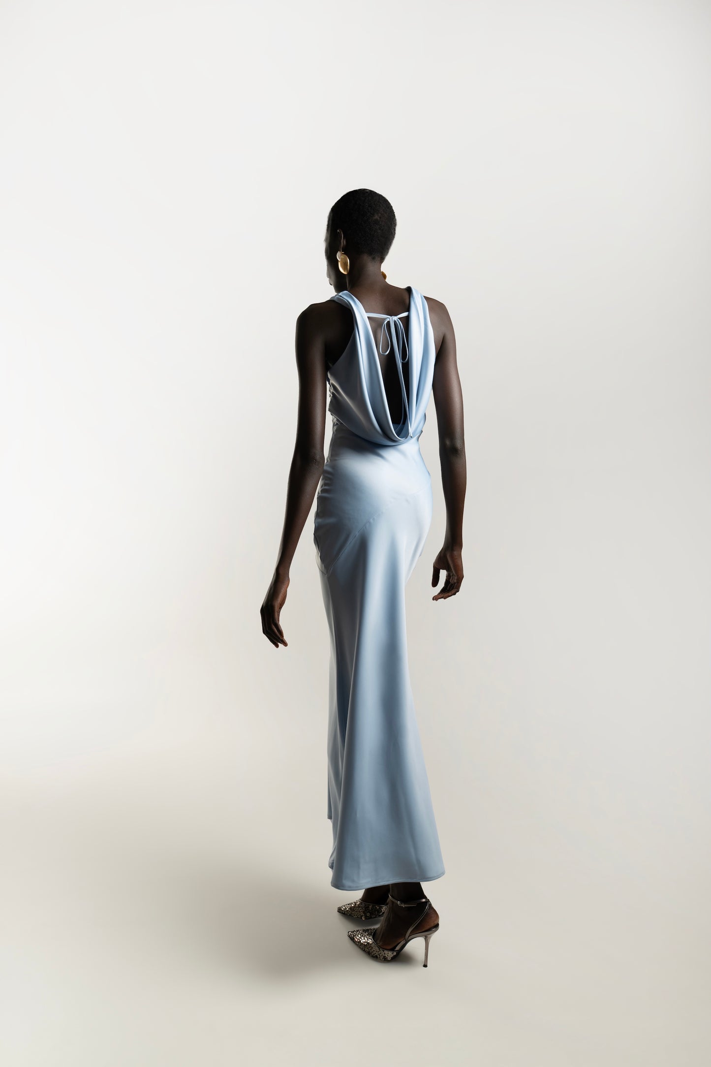 IRA by Irini Charalampous, @irathebrand online shop fashionable ready-to-wear womenswear brand KAIA satin basic maxi dress with open back and tie detail in powder blue color. Shop online from Cyprus and Greece.