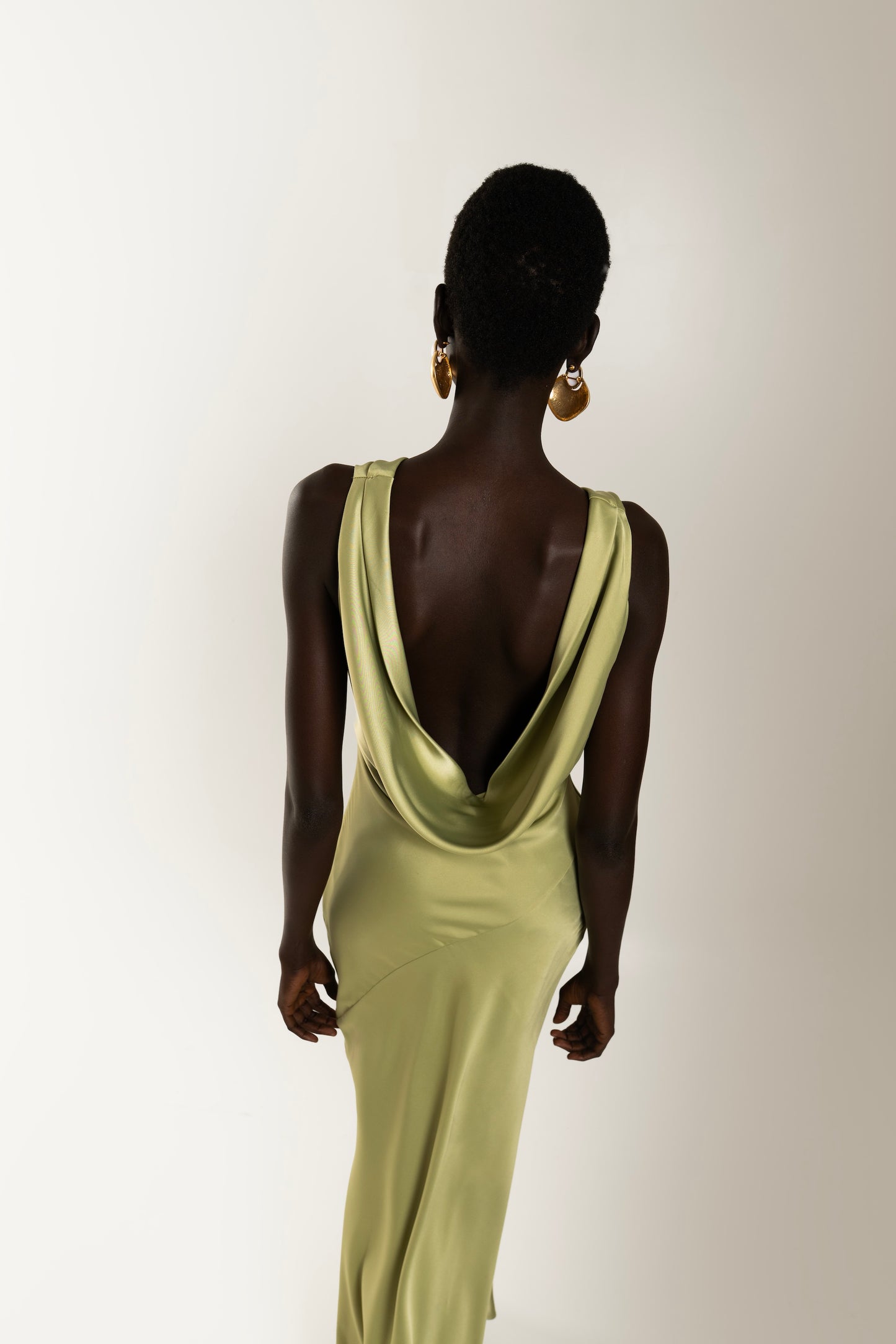 IRA by Irini Charalampous, @irathebrand online shop fashionable ready-to-wear womenswear brand KAIA satin basic maxi dress with open back and tie detail in olive green color. Shop online from Cyprus and Greece.
