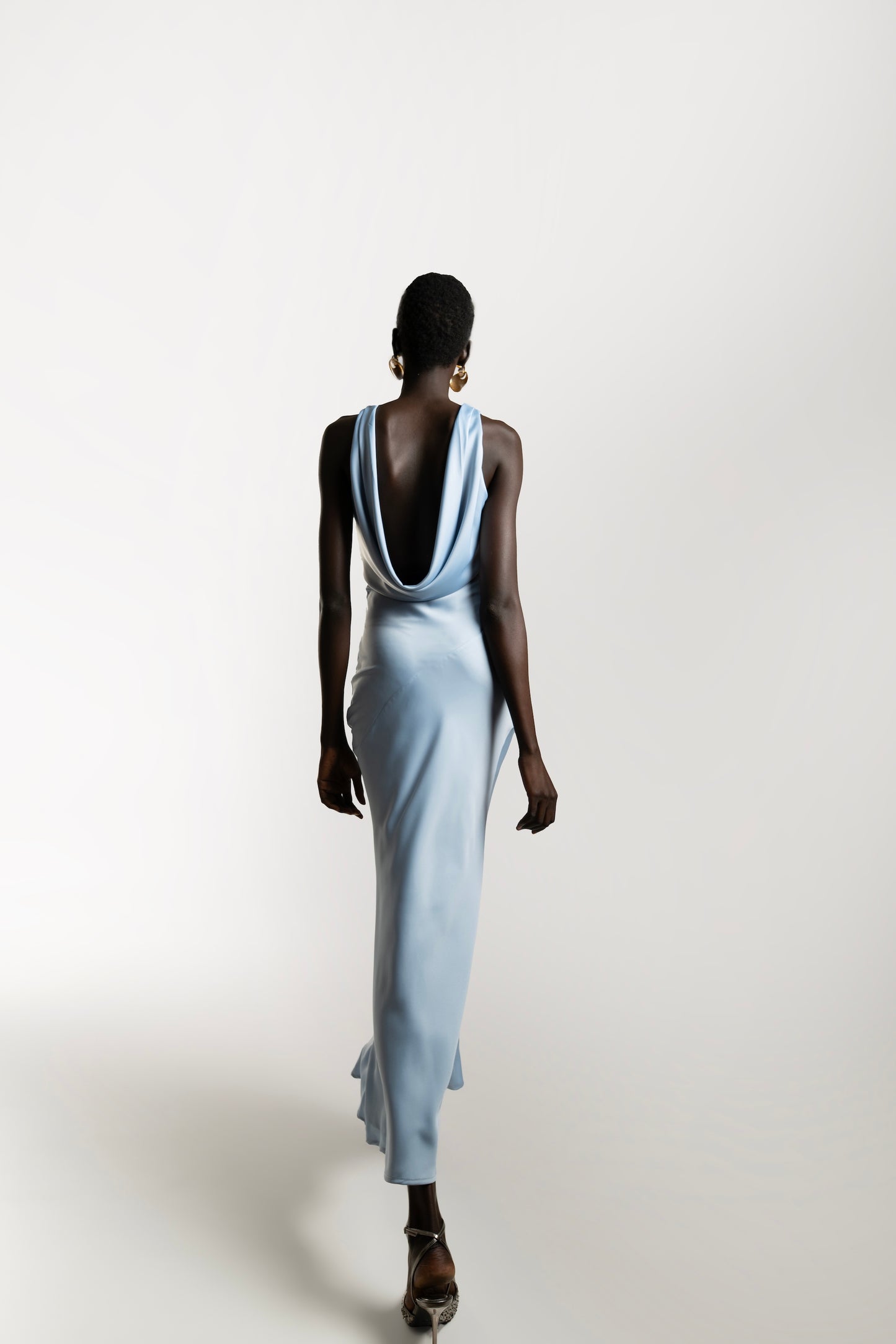 IRA by Irini Charalampous, @irathebrand online shop fashionable ready-to-wear womenswear brand KAIA satin basic maxi dress with open back and tie detail in powder blue color. Shop online from Cyprus and Greece.